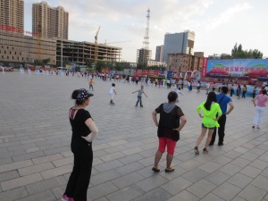 Recreational aerobic dancers in public square in Dong Sheng, China